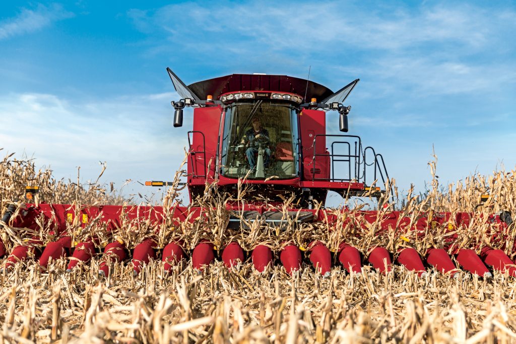 Image of a combine harvesting hay.